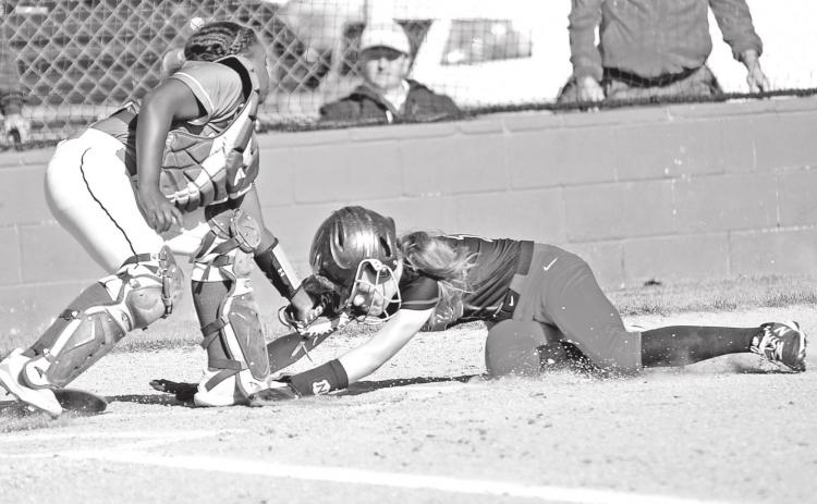 Eunice catcher Mckenzie Guillory tags out Belle Chasse base runner Olivia Clark. (Photo by Tom Dodge)