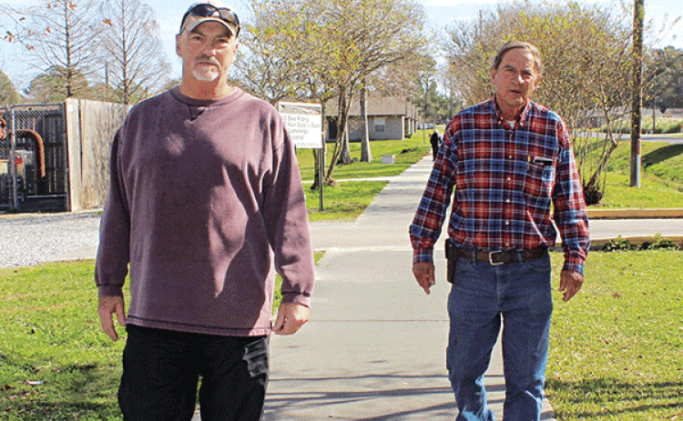 Above, Glynn Credeur, left, and Errol Larriviere, both of Eunice, enjoy the sunny morning Thursday as they took a walk at the Eunice Community Nature Trail. Walking weather will take a turn to the chilly side by Monday when lows begin dipping to below freezing. At right, Bryan Frey, of Eunice,  said he walks daily at the trail. (Photos by Myra Miller)