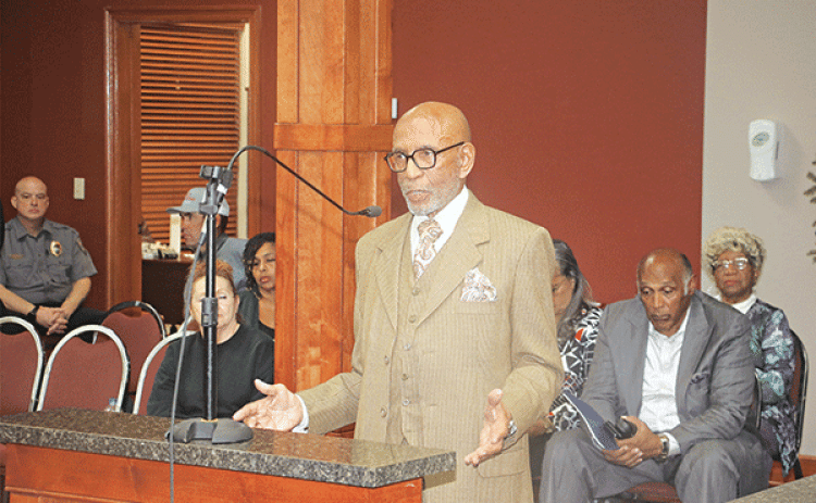 Opelousas attorney Elbert Guillory speaks at the St. Landry Parish Aministrative-Finance Committee meeting on Thursday in Opelousas. Seated, at right, is the Rev. Kerney Thomas, pastor of the Opelousas Life Church. (Photo by Harlan Kirgan)