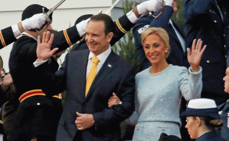 Gov.-elect Jeff Landry and how wife, Sharon, wave as they walk down the capitol steps on Sunday for the inauguration ceremony.(Photo by Harlan Kirgan)