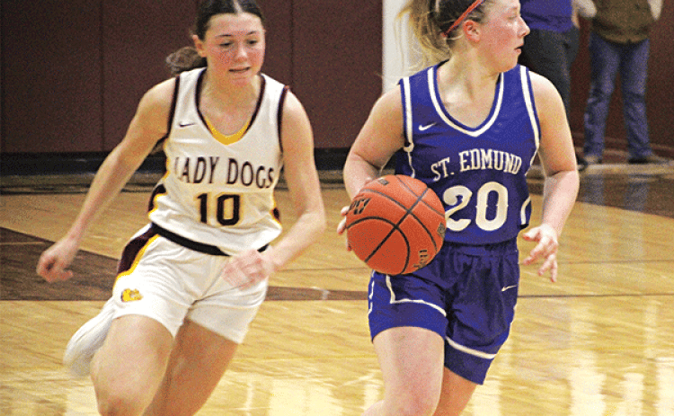 St. Ed’s junior Ava Smith dribbles looking for a teammate to pass to during Friday night’s win against Iota that improved the team’s overall record to 14-3. (Photo by Rhett Manuel)