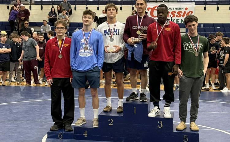 St. Edmund sophomore wrestler Cooper Berzas, third from left, stands holding his trophy among others at the Ken Cole Invitational competition. (Submitted photo)