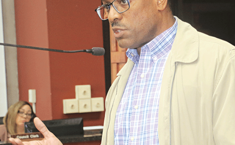 Herman Fuselier, St. Landry Parish Tourist Commission executive director, reviews tourism statistics at the St. Landry Parish Council meeting on Wednesday in Opelousas. (Photo by Harlan Kirgan)