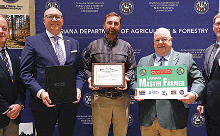 Trent Broussard, of Acadia Parish, was designated a Louisiana Master Farmer at a Jan. 12 ceremony. From left, are Michael Salassi, director of the Louisiana Agricultural Experiment Station; Matt Lee, interim LSU vice president for agriculture; Broussard; Mike Strain, commissioner of the Louisiana Department of Agriculture and Forestry; and Chad Kacir, of the Natural Resources Conservation Service. (Photo by Olivia McClure/LSU AgCenter)