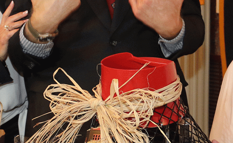Sen. Bill Cassidy looks over a crawfish trap filled with gifts. (Photo by Harlan Kirgan)