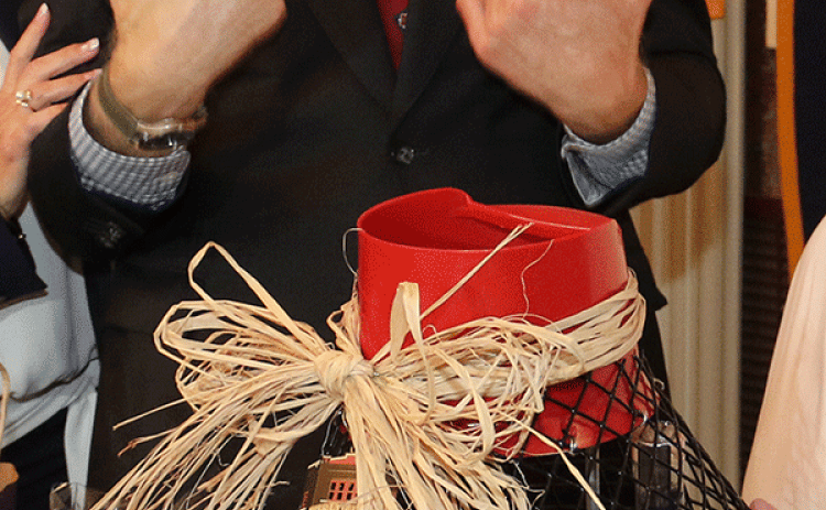 Sen. Bill Cassidy looks over a crawfish trap filled with gifts. (Photo by Harlan Kirgan)