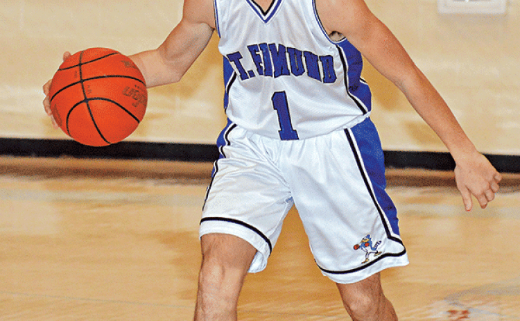 St. Edmund’s Owen Cart brings the ball down the court against Iota. (Photo by Tom Dodge)
