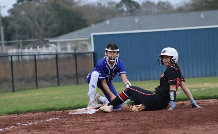 Pictured is St. Ed player Rory Langlinais tagging a Bunkie player out at third base. (Photo by Amy Myers)