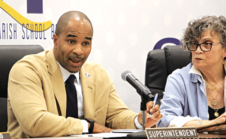St. Landry Parish School Superintendent Milton Batiste talks about the weather extremes in January as Board President Mary Ellen Donatto listens at Thursday’s meeting in Opelousas. (Photo by Harlan Kirgan)