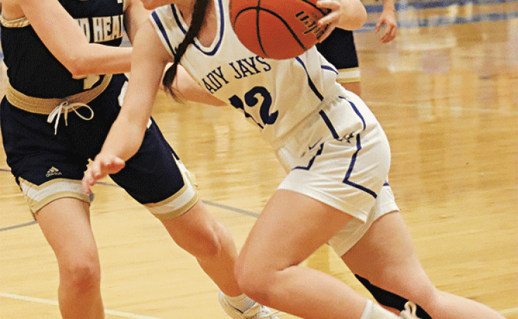 St. Edmund’s Caroline Lavergne drives past Sacred Heart defenders as the Lady Jays win 56-38. (Photo by Amy Myers)