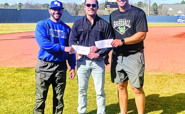 Perry Pitre Ford’s Perry Pitre IV presents a donation check to St. Edmund head baseball coach Casey Charlie and Eunice High head baseball coach Stuart Turner. The two schools put on the annual Perry Pitre Ford Jamboree every year. The two-day event features junior varsity programs on Friday night and varsity programs on Saturday. (Submitted photo)