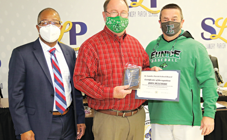 John McLemore, center, was honored on his retirement from Eunice High School and 33 years of service at Thursday’s St. Landry Parish School Board meeting in Opelousas. From left, are Superintendent Patrick Jenkins, McLemore, and Eunice High Principal Mitch Fontenot. (Photos by Harlan Kirgan)
