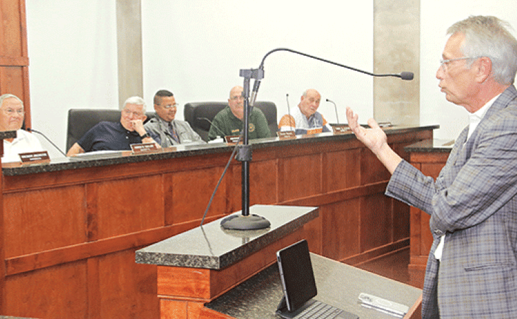 Eric Lafleur, right, a bond attorney, speaks to the St. Landry Parish Council on Wednesday. Council members seated from left are Harold Taylor Ken Marks, Dexter Brown, Timmy Lejeune and Ernest Blanchard. (Photo by Harlan Kirgan)