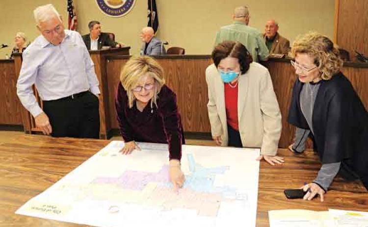 From left, demographer Mike Hefner, Alderwoman Connie Thibodeaux, Margaret Frey and Celeste Gomez look over the ward lines approved at Tuesday’s city meeting. The full map is on Page 12. (Photo by Harlan Kirgan)