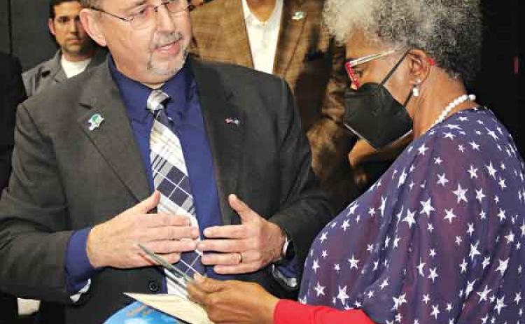 St. Landry Parish President Jessie Bellard, left, presents Pat Mason-Guillory with the President’s Award during the State of the Parish ceremony held Thursday in the Delta Grand Theater in Opelousas. The event was the first for the award and the address. In the rear, center, is Richard Lewis, who serve as master of ceremonies. Lewis is the parish’s code enforcement officer. (Photos by Harlan Kirgan)