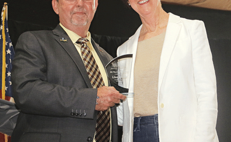 Lisa Miller, right, St. Landry Parish Health Unit director, was presented with a Retirement Award at the State of hte Parish event held Monday at Eunice High School. Presenting the award is Parish President Jessie Bellard.
