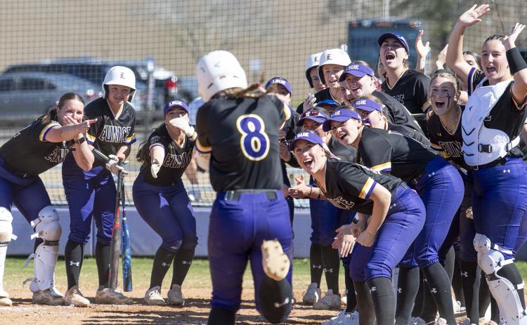 Jordan Stanley (8) met by teammates at home plate after hitting a home run vs. Kirkwood. (Photo by Travis Webb)