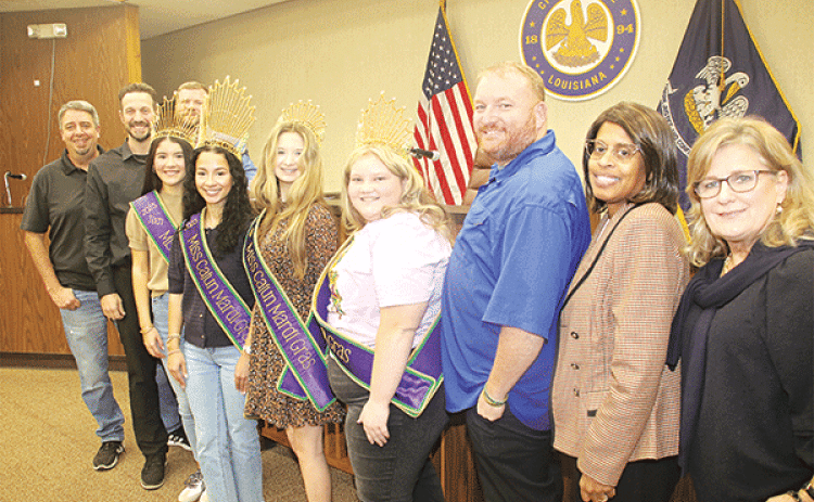 Adding a carnival season look are four Cajun Mardi Gras Festival queens. They were introduced at the Tuesday Eunicy city council meeting and after the meeting lined up for a photo. From left, are Mayor Scott Fontenot, Alderman Chad Andrepont, Teen Cajun Mardi Gras Landri Young, Junior Cajun Mardi Gras; Akashaa Hall,  Deb Cajun Mardi Gras Chloe Fontenot, Junior Cajun Mardi Gras Emma-Kate Reed, Alderman Randall Reed, Alderwoman Germaine Simpson and Alderwoman Connie Thibodeaux. Mardi Gras is scheduled from Fe
