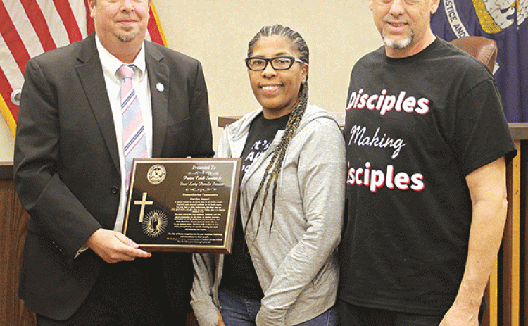 Five community service awards were given at Thursday’s Eunice Board of Aldermen’s meeting. Mayor Scott Fontenot presents an award to Pamela and Caleb Semien of Word Ministries Church. More photos are on Page 5. (Photo by Harlan Kirgan)