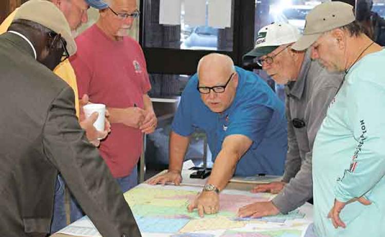 Prior to the start of Thursday night’s redistricting meeting, members of both the Acadia Parish School Board and the Acadia Parish Police Jury discuss the proposed new lines. From left, are Bishop James Proctor, School Board District 1; Gordon Ray Morgan, Police Jury District 4; Ike Richard, School Board District 6; Doug LaCombe, School Board District 2; Pat Daigle, Police Jury District 7; and James Higginbotham, School Board District 7. (Photo by Steve Bandy/Crowley Post-Signal)