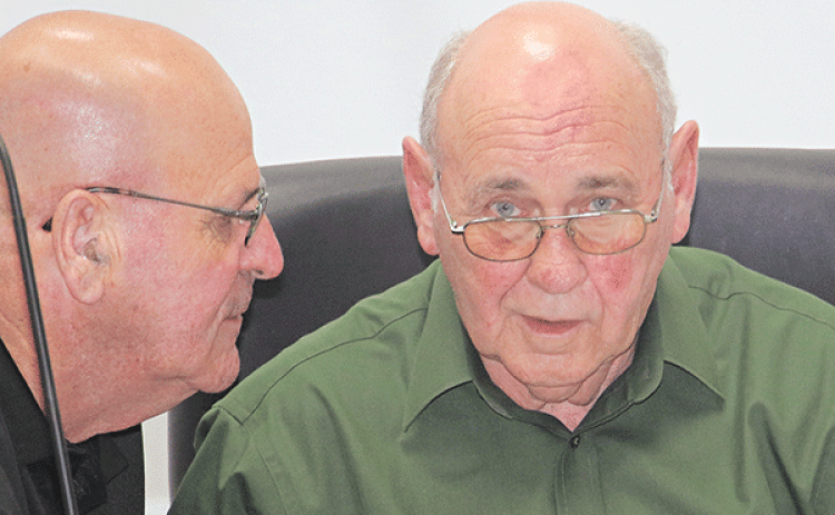 St. Landry Parish Council members, from left, Timmy Lejeune and Ernest Blanchard before Wednesday’s meeting in Opelousas. (Photo by Harlan Kirgan)