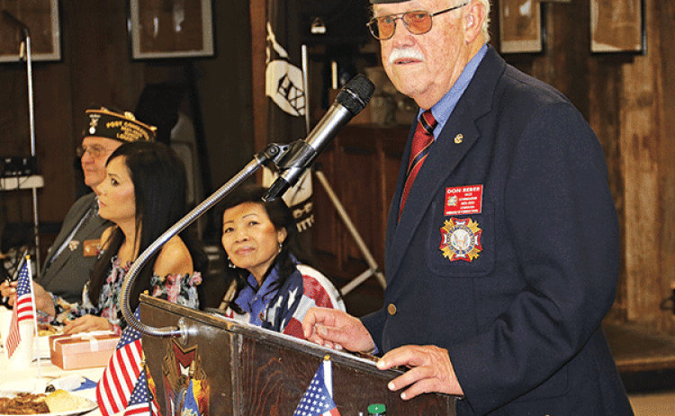 Louisiana VFW State Commander Don Reber speaks at his homecoming celebration on Saturday at the Veterans of Foreign Wars Post 8971 in Eunice. About 170 VFW leaders and members from across the state participated in the  event that honors the state commander. Seated from left, are Donnie Fontenot, Post 8971 commander, Mary Miller, Reber’s daughter, and Thuy Reber, the commander’s wife. (Photos by Harlan Kirgan)