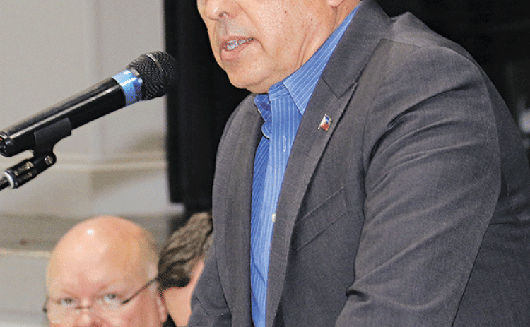 Economic developer Bill Rodier speaks at the State of the Parish meeting in Opelousas on Feb. 7. Seated at left is Van Reed, of Eunice, a St. Landry Parish Government administrator. (Photo by Harlan Kirgan)