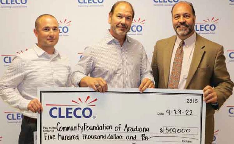 Andre Guillory, left, vice president and chief customer officer, and Bill Fontenot, center, president and CEO of Cleco Corporate Holdings, present a $500,000 check to Raymond Hebert, right, CEO of the Community Foundation of Acadiana. (Submitted photo)