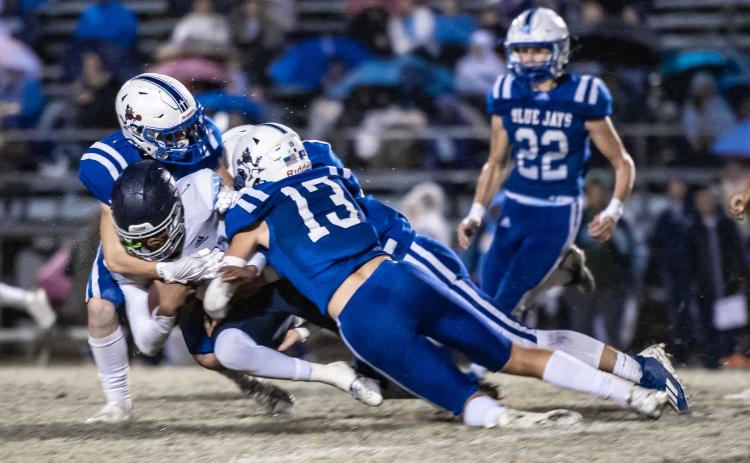 St. Ed's Copeland Miller and several Blue Jay defenders surround WCA ball carrier Stephen George. (Photo by Dwight Jodon)
