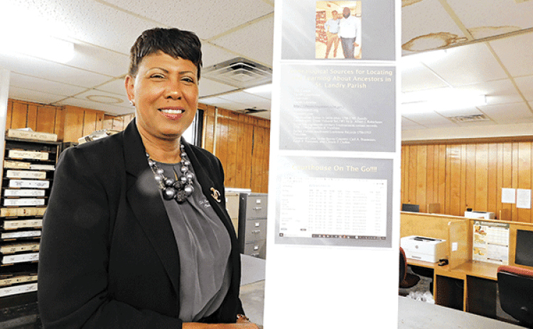 St. Landry Parish Clerk of Court employee Debra Sostand displays one of the several exhibits. (Submitted photo)