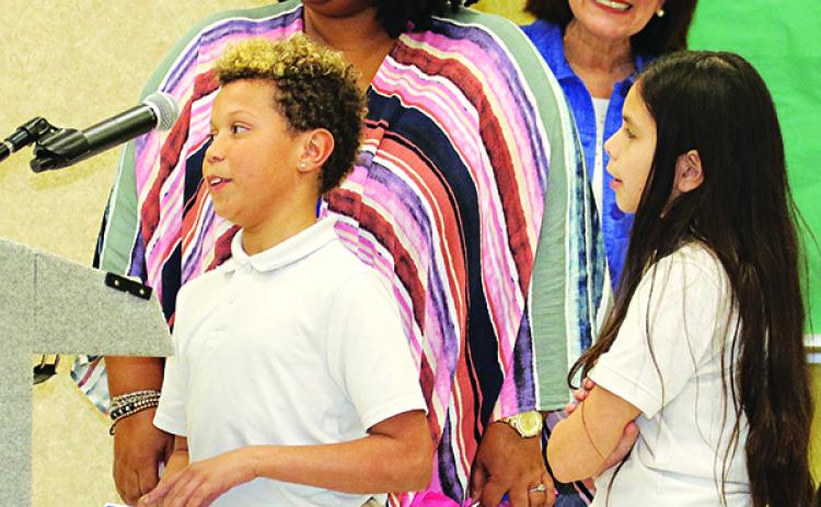 Central MIddle School Leader In Me students, from  left, Jayden Archangel and Zoey Fisher introduce themselves to the St. Landry Parish School Board at Thursday’s meeting. With them, from left are Principal Shelsy Williams and Early Childhood Education Director June Inhern. Each month Leader in Me students help with award presentations at the  School Board meeting. (Photo by Harlan Kirgan)
