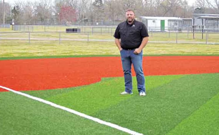 Robert Johnson, the city’s recreation director, stands on the infield turf at the Recreation Complex. (Photo by Tom Dodge)