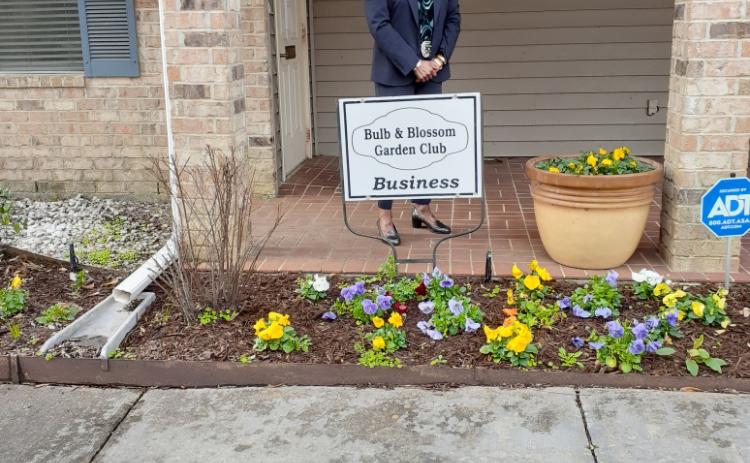 Angelia Guillory accepts the Bulb's Business Garden of the Month marker