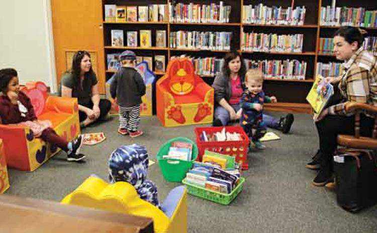 Mallory Moser, a volunteer, read a story book, “Goodnight Train,” by June Sobel, to children Wednesday morning during the library’s Story Time. Children of all ages are welcome to attend Story Time at 10 a.m. on Wednesdays in the upstairs children’s section at the library. The kids also enjoyed creating a craft and had a snack. (Photo by Myra Miller)