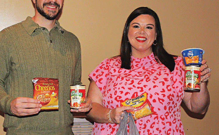 Belly Buddies, a program to fight childhood hunger, has been in existence nearly 10 years, and is hoping to expand. Chad Andrepont, the board president; and Katie Richard, the founder and executive director of the non profit program are with food items. Suggested food items are ones that are easy to open and prepare by a child. (Photo by Myra Miller)
