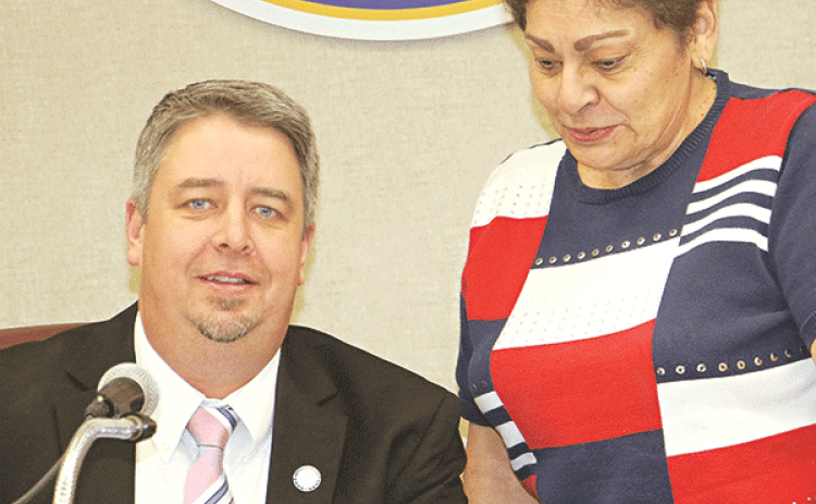 Eunice Mayor Scott Fontenot signs a pledge for a city cleanup in 2026 to mark the 250th year since the Declaration of Independence. With the mayor is Donna Baltakis, director of Keep Eunice Beautiful. (Photo by Harlan Kirgan)