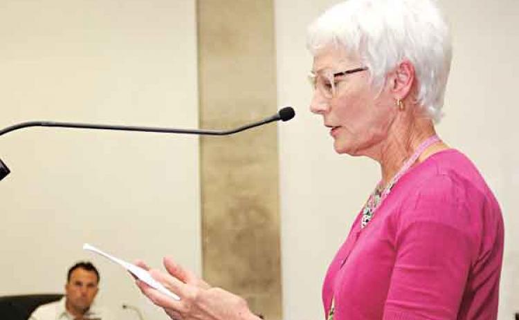 Ruth Andrus, of the United Daughters of the Confederacy, reads a statement from her organization about Confederate memorials at the St. Landry Parish Council meeting on Wednesday in Opelousas. At left is Council member Coby Clavier. (Photo by Harlan Kirgan)