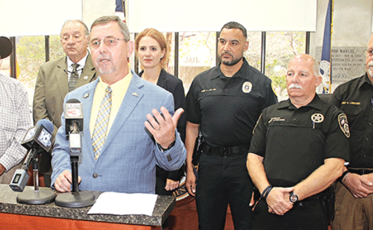 St. Landry Parish President Jessie Bellard announced on Thursday parish law enforcement agencies would share in $1.8 million in federal funding for technology upgrades such as body cameras and radios. From left, are Opelousas City Marshal Paul Mouton, Sheriff Bobby Guidroz, Bellard, Assistant District Attorney Alisa Gothreaux, Opelousas Police Chief Graig LeBlanc, Eunice City Marshal Terry Darbonne and Eunice Police Chief Kyle LeBouef. (Photos by Harlan Kirgan)