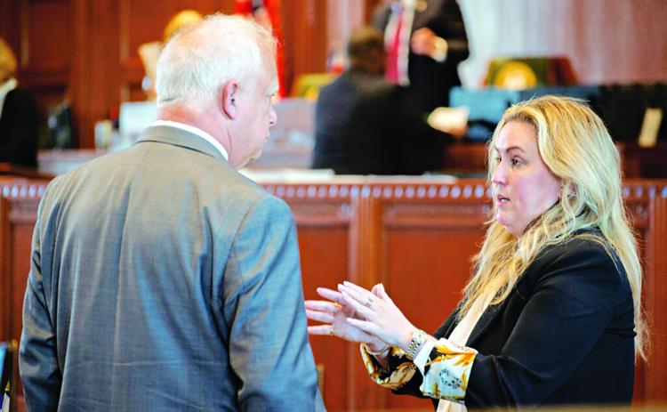 Rep. Julie Emerson, R-Carencro, speaking to Rep. Charles Owen in the House Chamber. (Allison Allsop/ Louisiana Illuminator)