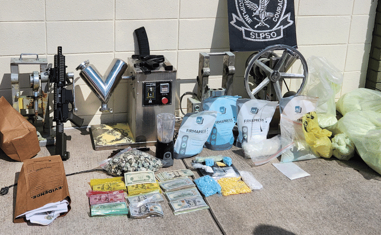 Drugs, guns and pill-making gear seized in drug bust. (St. Landry Parish Sheriff's Office photo)