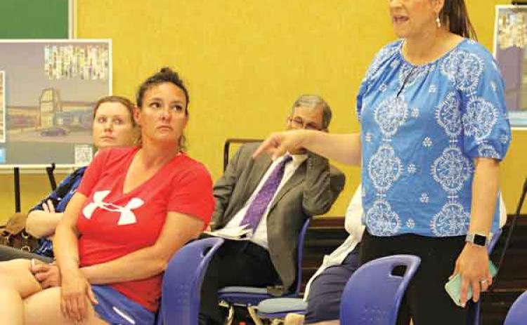 Kristin Bullard, standing at right, a Leonviille Elementary School teacher, at Tuesday’s St. Landry Parish School Board committee meeting.