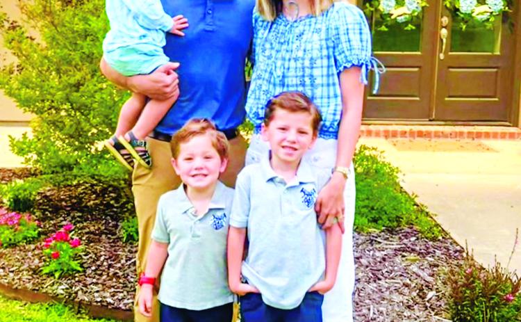 St. Edmund new head football coach Jacob Aguillard, his wife and his three sons.
