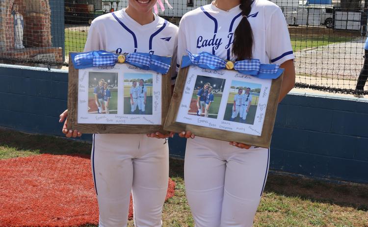 St. Edmund celebrated their seniors softball ladies Monday and gifted them with picture collages, letters from teammates and baskets of goodies. From left are Caroline Lavergne and Aubrie LeJeune. (Photo by Amy Myers)