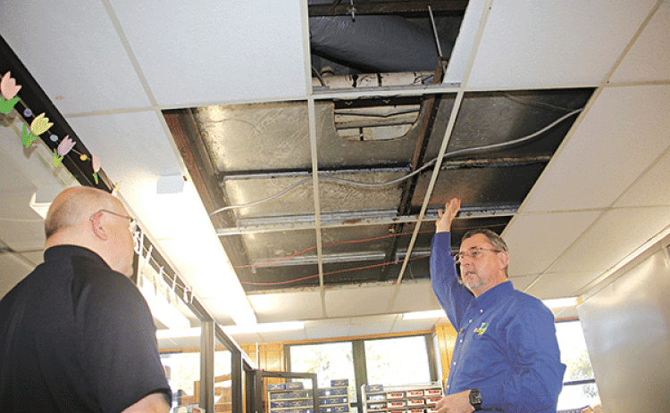 St. Landry Parish President Jessie Bellard, right, shows where smelly water flooded Room 206 in the St. Landry Parish Courthouse on Monday. With Bellard is Van Reed, director of emergency preparedness and a parish administrator.