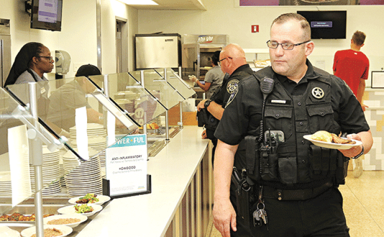 Eunice Deputy Chief Marshal Joey Peloquin goes through the serving line at LSUE as part of a program by LSUE Dining to honor local heroes.