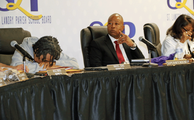After about two hours in closed session and another hour of meeting left, St. Landry Parish School Board member Hazel Sias briefly put her head down. The Board decided Thursday night to oust Superintendent Patrick Jenkins, center, in a buyout. At right is Board President Joyce Haynes. Jenkins will be paid through June 30 when his contract expires. (Photo by Harlan Kirgan)