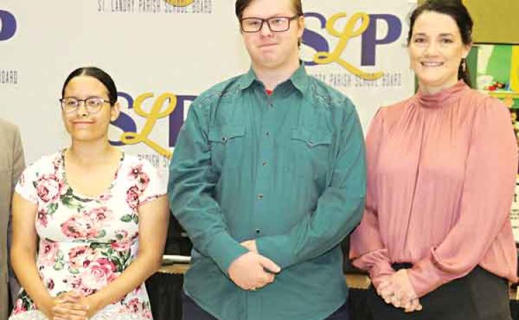 Two Eunice High School students, Baylie Guillory and Dylan Fuselier, were recognized at the St. Landry Parish School Board meeting Thursday. The students are the first in the state to earn dual enrollment technical college degrees. They attended the Eunice Career and Technical Educational Center and South Louisiana Community College where they earned degrees in Culinary Arts and Occupations. With them is Aimee Summerlin of the Eunice Career and Technical Educational Center. (Photo by