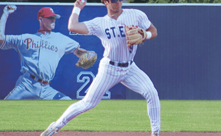 St. Edmund’s Kane West is in action against Comeaux High on April 14. (Photo by Amy Myers)