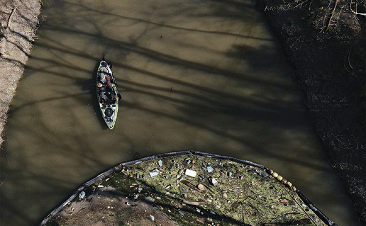 A boom traps litter in Bayou Fountain. (Photo provided by Jeff Kuehny)