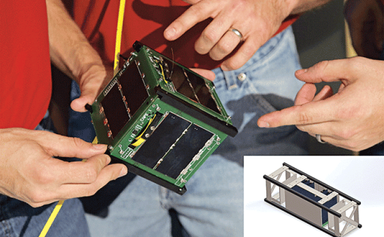 NASA has selected UL Lafayette’s CAPE satellite team for a return trip to space. Student researchers will design and build a larger, more sophisticated version of past satellites. The new model (inset) will be launched into space at an as-yet-undetermined date to gather data about radiation levels. (Photo from the University of Louisiana at Lafayette)